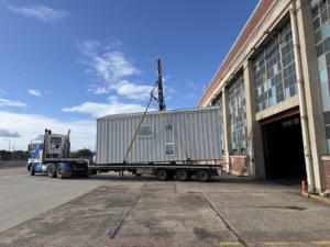 A Nexus Communities modular pod being transported from the factory to its installation site.